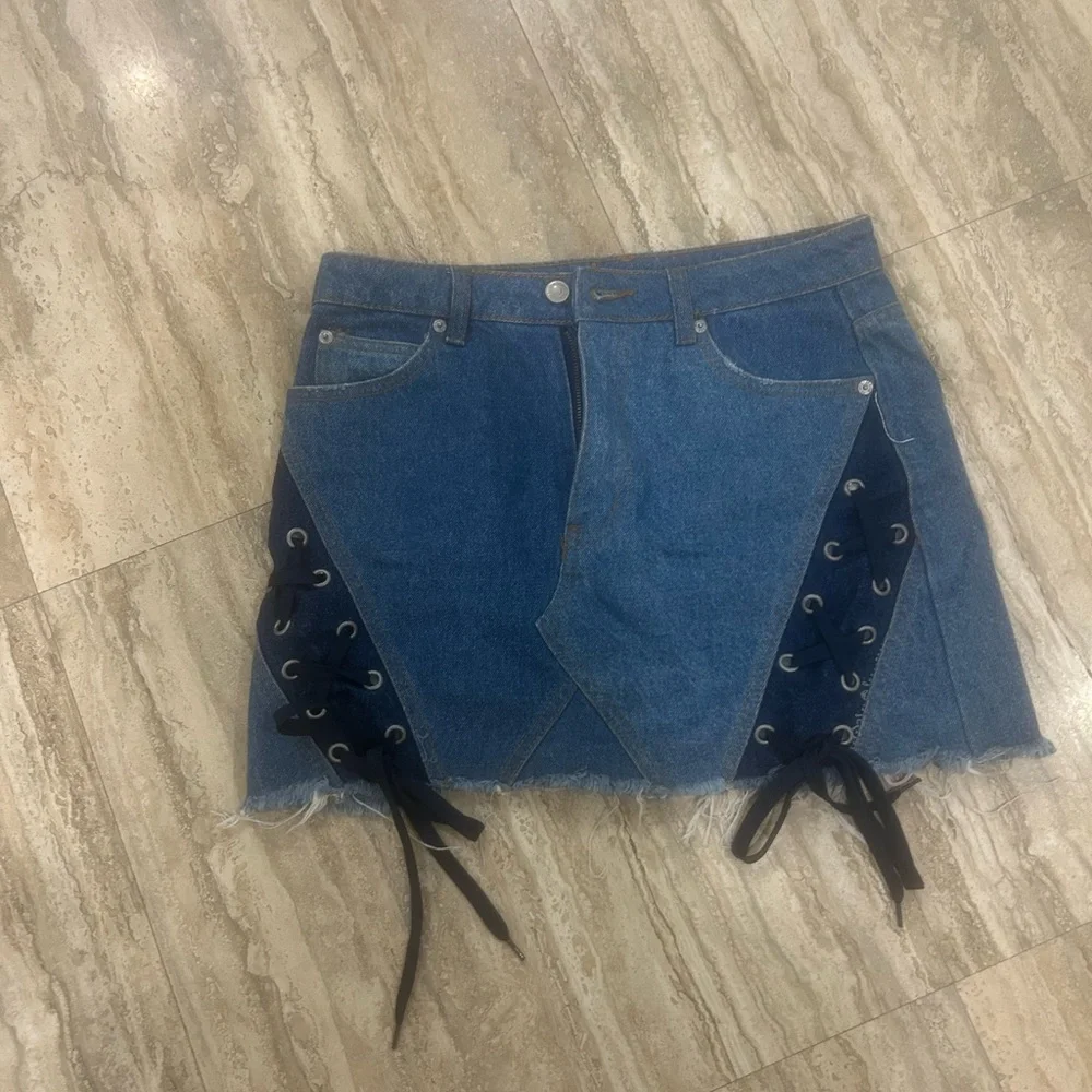 Denim Skirt with Lace-Up Detail fits like a medium